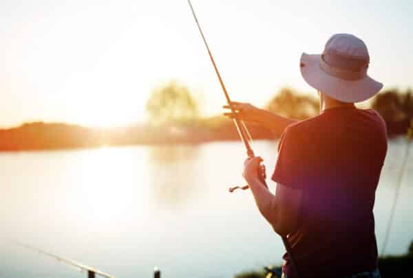 Student fishing at sunset on a lake near Muncie, IN