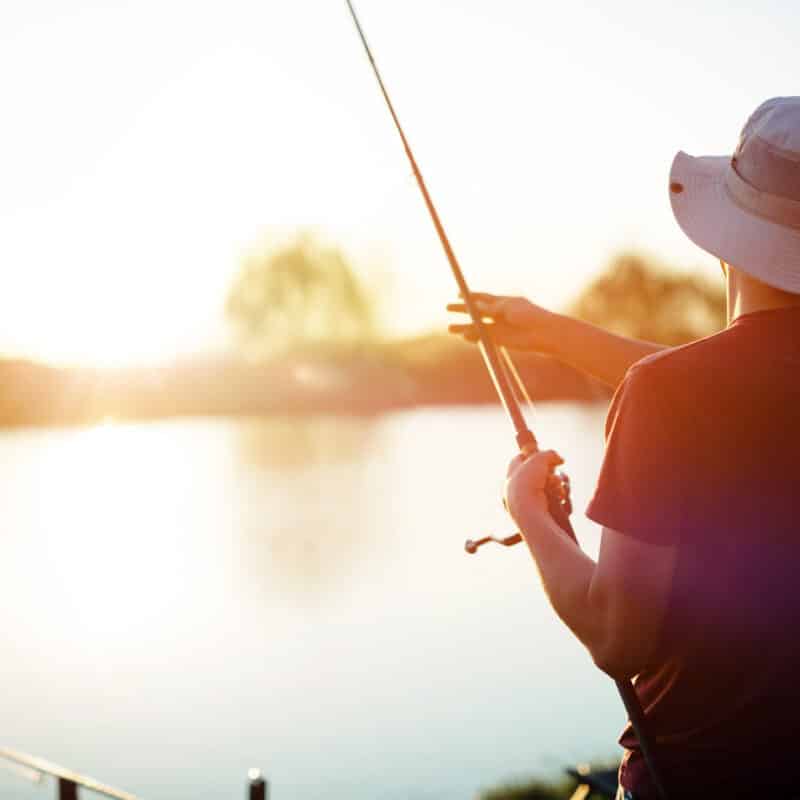 Student fishing at sunset on a lake near Muncie, IN
