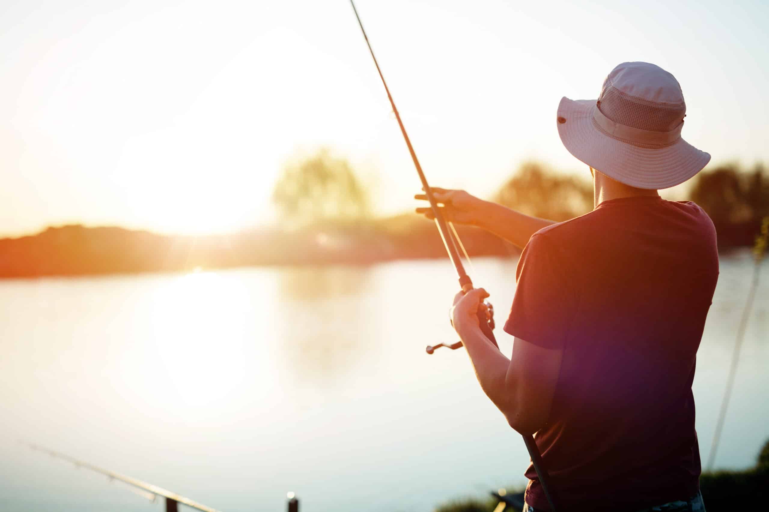 Student fishing at sunset on a lake near Muncie, IN